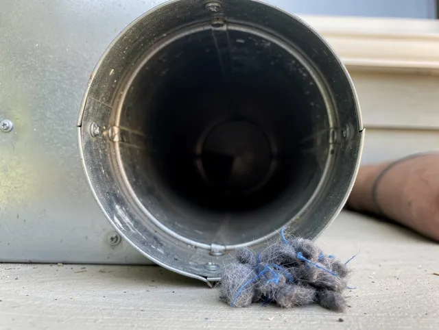 Northbridge Dryer Vent Cleaning technician using specialized equipment to clear severe dryer vent blockage in Northbridge